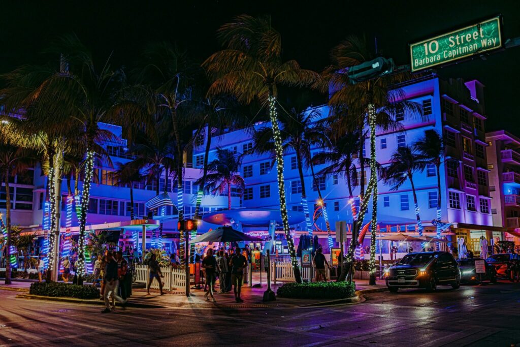Neon-lit Ocean Drive with palm trees in Miami Beach at night