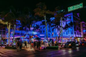 Neon-lit Ocean Drive with palm trees in Miami Beach at night